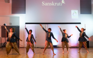 Children dancing in blue and gold costumes